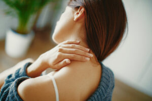 Close up of a woman massaging her neck